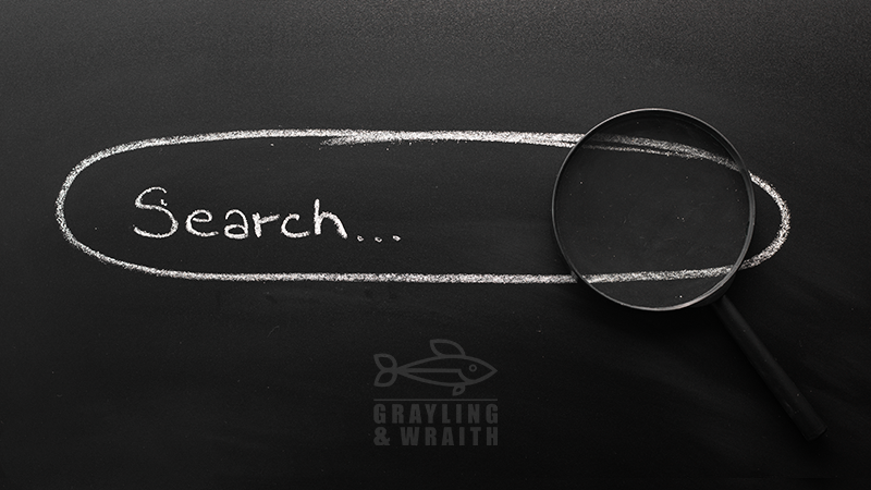 A magnifying glass on a blackboard highlights "Search...," representing seo services for small businesses as a gateway to enhancing website visibility and traffic organically.