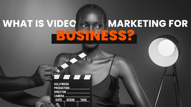 A monochrome image of a person with a clapperboard, representing the preparation and execution involved in video marketing for businesses.
