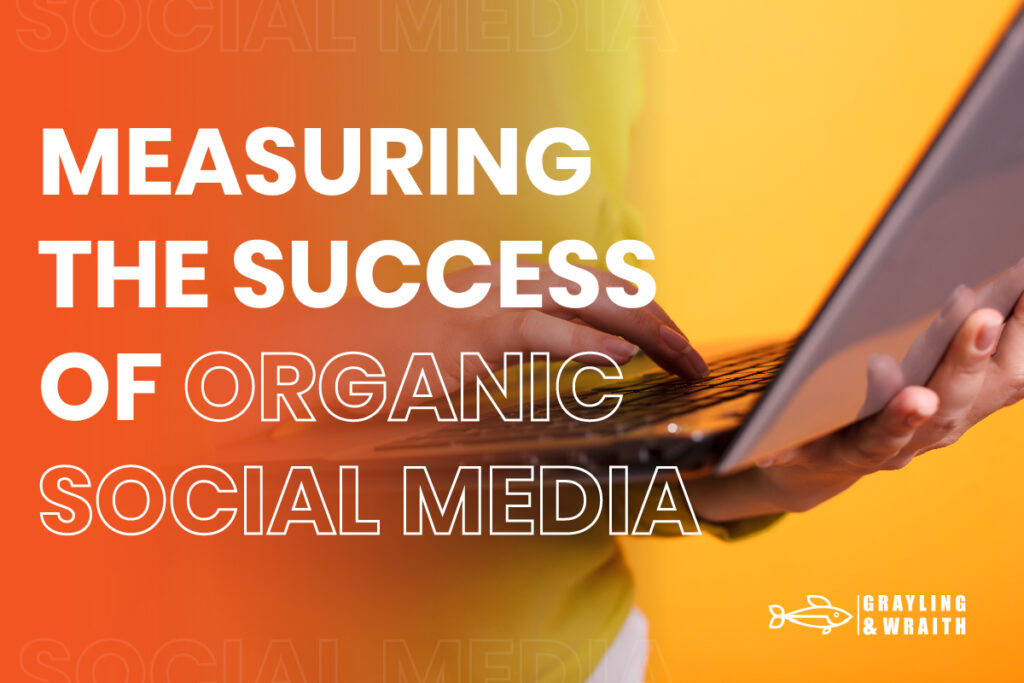 Measuring the Success of Organic Social Media - Hands typing on a laptop with a bright orange and yellow background.